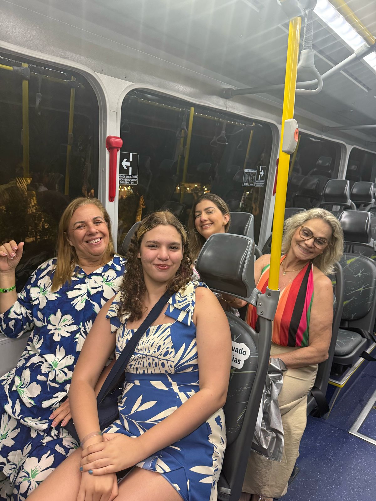 Grupo sentado no ônibus interno do resort.